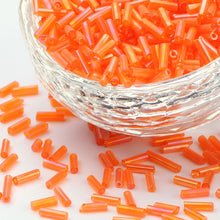 Load image into Gallery viewer, Pack of 32g Transparent AB Glass Bugle Beads 6 x 1.8mm - Orange